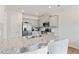 Bright kitchen with a granite island, stainless appliances, and gray cabinets at 7200 Brigidoon Rose, Douglasville, GA 30134