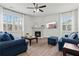 Cozy living room with a fireplace, large windows, and comfortable seating at 7200 Brigidoon Rose, Douglasville, GA 30134