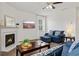 Cozy living room with a fireplace, a ceiling fan and comfortable seating at 7200 Brigidoon Rose, Douglasville, GA 30134