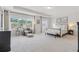 Spacious main bedroom with large windows, neutral decor, and a comfortable seating area at 7200 Brigidoon Rose, Douglasville, GA 30134