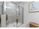Shower with glass doors, tiled walls, and built-in shelving at 7200 Brigidoon Rose, Douglasville, GA 30134