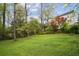 Expansive backyard with mature trees, lush lawn, and a view of the home at 78 Beverly Ne Rd, Atlanta, GA 30309