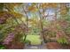 Lush backyard with Japanese maple trees, stone steps, and vibrant landscaping at 78 Beverly Ne Rd, Atlanta, GA 30309