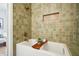 Elegant bathroom featuring a soaking tub with unique green tiling at 78 Beverly Ne Rd, Atlanta, GA 30309