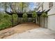 Carport with hanging ferns, gravel, stepping stones, and a white brick wall at 78 Beverly Ne Rd, Atlanta, GA 30309