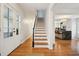 Inviting foyer with hardwood floors, staircase, and views into the kitchen and other living spaces at 78 Beverly Ne Rd, Atlanta, GA 30309