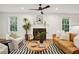 Cozy living room featuring a fireplace, hardwood floors, and ample seating with natural light at 78 Beverly Ne Rd, Atlanta, GA 30309