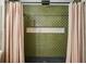 Shower with green tiling, neutral colored inset, black drain, and light pink curtain at 78 Beverly Ne Rd, Atlanta, GA 30309