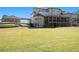 Large, level backyard featuring a covered porch, balconies, and a detached garage connected by a breezeway at 150 White Tail Ct, Fayetteville, GA 30214