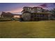 Expansive backyard featuring a covered porch, balconies, and a large level lawn at 150 White Tail Ct, Fayetteville, GA 30214