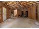 Unfinished basement featuring exposed framing and ceiling, offering potential for customization at 150 White Tail Ct, Fayetteville, GA 30214