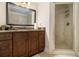 Bathroom with granite countertops, dark brown cabinets, and a glass enclosed shower at 150 White Tail Ct, Fayetteville, GA 30214