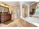 Elegant bathroom with tile surround, a large soaking tub, and refined fixtures at 150 White Tail Ct, Fayetteville, GA 30214