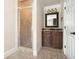 Bathroom with glass shower, vanity with granite countertop, and tiled floor at 150 White Tail Ct, Fayetteville, GA 30214