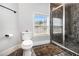 Modern bathroom with black marble shower, dark floor, and a window for natural light at 150 White Tail Ct, Fayetteville, GA 30214