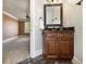 Bathroom vanity with dark wood cabinets and a granite countertop next to a bedroom at 150 White Tail Ct, Fayetteville, GA 30214