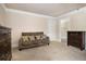 Neutral bedroom features crown molding, a cozy couch with decorative pillows, and dark wood furniture at 150 White Tail Ct, Fayetteville, GA 30214