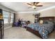Bright bedroom features a ceiling fan, natural light, bed, desk, and a bookshelf at 150 White Tail Ct, Fayetteville, GA 30214