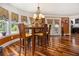 Eat-in dining area with a chandelier, hardwood floors, and natural light from large windows at 150 White Tail Ct, Fayetteville, GA 30214
