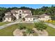 Stately home featuring multiple gables, a porte-cochere and a circular driveway, set on expansive lawn at 150 White Tail Ct, Fayetteville, GA 30214