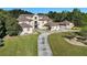 Luxury home with a prominent balcony, manicured lawn, and convenient circular driveway at 150 White Tail Ct, Fayetteville, GA 30214