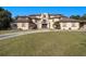 Expansive luxury home with a circular driveway and well manicured lawn at 150 White Tail Ct, Fayetteville, GA 30214