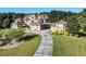 Stately home with manicured lawn, professionally landscaped grounds, and a long driveway at 150 White Tail Ct, Fayetteville, GA 30214