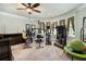 Spacious home gym features multiple exercise machines and large windows for natural light at 150 White Tail Ct, Fayetteville, GA 30214