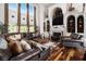 Bright living room featuring hardwood floors, large windows, and comfortable leather seating at 150 White Tail Ct, Fayetteville, GA 30214