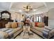 Opulent main bedroom featuring tray ceiling, neutral tones and sitting area at 150 White Tail Ct, Fayetteville, GA 30214
