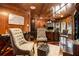 Handsome wood paneled office with custom built-ins and a comfortable seating area at 150 White Tail Ct, Fayetteville, GA 30214