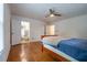 Bedroom featuring wood floors, ceiling fan, and a door that leads to an en-suite bathroom at 354 Greenwood Ave, Decatur, GA 30030