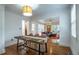 Open dining area that connects to a living room with a cozy sectional and great natural light at 354 Greenwood Ave, Decatur, GA 30030