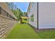 Side yard with retaining wall offers ample outdoor green space at 399 Tillman Pass, Woodstock, GA 30188
