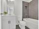 Bathroom with a shower over tub, grey tile wall and modern vanity at 399 Tillman Pass, Woodstock, GA 30188
