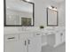 Bright bathroom with double vanity, white cabinets, quartz countertop and modern fixtures at 399 Tillman Pass, Woodstock, GA 30188