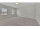 Large, bright bedroom with carpet flooring and two windows at 399 Tillman Pass, Woodstock, GA 30188
