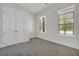Neutral bedroom featuring carpeted floors, large closet, and multiple windows for plenty of light at 399 Tillman Pass, Woodstock, GA 30188