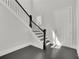 Elegant entryway features a staircase with black iron railings and hardwood floors at 399 Tillman Pass, Woodstock, GA 30188