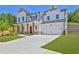 Charming two-story home with a two-car garage, manicured lawn, and inviting front porch at 399 Tillman Pass, Woodstock, GA 30188