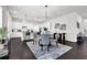 Open-concept kitchen features white cabinets, pendant lighting, stainless appliances, and a breakfast bar at 399 Tillman Pass, Woodstock, GA 30188