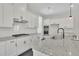 Modern kitchen features granite counters, stainless appliances, white cabinets, and a stylish faucet at 399 Tillman Pass, Woodstock, GA 30188