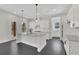 Bright kitchen featuring a center island with seating, white cabinets, and stainless appliances at 399 Tillman Pass, Woodstock, GA 30188