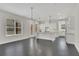 Open-concept kitchen and living area with modern fixtures, ample windows and dark hardwood floors at 399 Tillman Pass, Woodstock, GA 30188