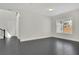 Open living space with dark floors, natural light, and modern fixtures at 399 Tillman Pass, Woodstock, GA 30188