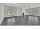 Bright living room with fireplace, big windows, and gray hardwood floors at 399 Tillman Pass, Woodstock, GA 30188
