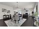 Bright and airy living room features a modern chandelier, dark floors, and stylish decor at 399 Tillman Pass, Woodstock, GA 30188