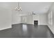 Bright living room with a fireplace, large windows, and sleek gray flooring at 399 Tillman Pass, Woodstock, GA 30188