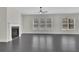 Bright living room with fireplace, big windows, and gray hardwood floors at 399 Tillman Pass, Woodstock, GA 30188