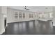 Spacious living room with dark floors, a fireplace, and large windows offering plenty of natural light at 399 Tillman Pass, Woodstock, GA 30188